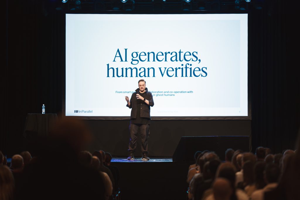 Speaker presenting on stage at Grand One AI Day 2025